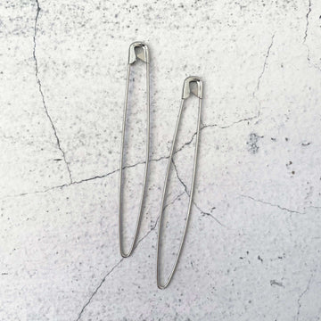 Two safety pin style steel Safety Stitch Holders by Birch Creative brand.